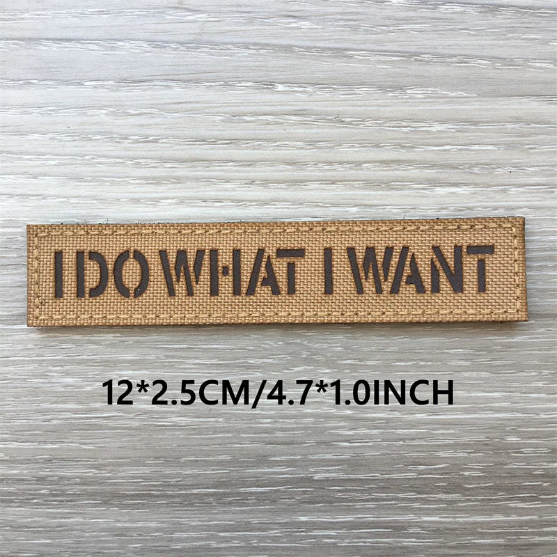 Brown woven patch with black text reading I DO WHAT I WANT, measuring 12x2.5cm or 4.7x1.0inch.