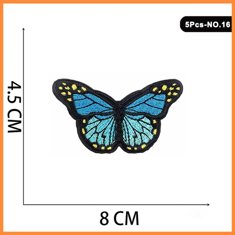 A butterfly embroidered iron-on patch featuring blue and yellow details.
