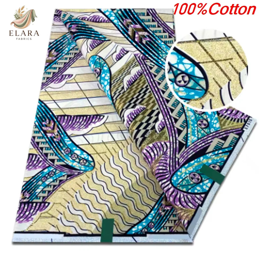 A close-up view of a pink glitter African wax print fabric featuring purple, teal, and gold patterns.