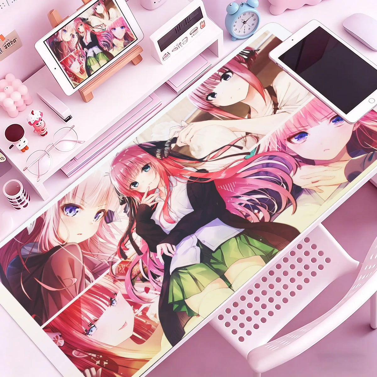 A pink and purple anime themed mouse pad featuring characters, displayed on a desk mat.