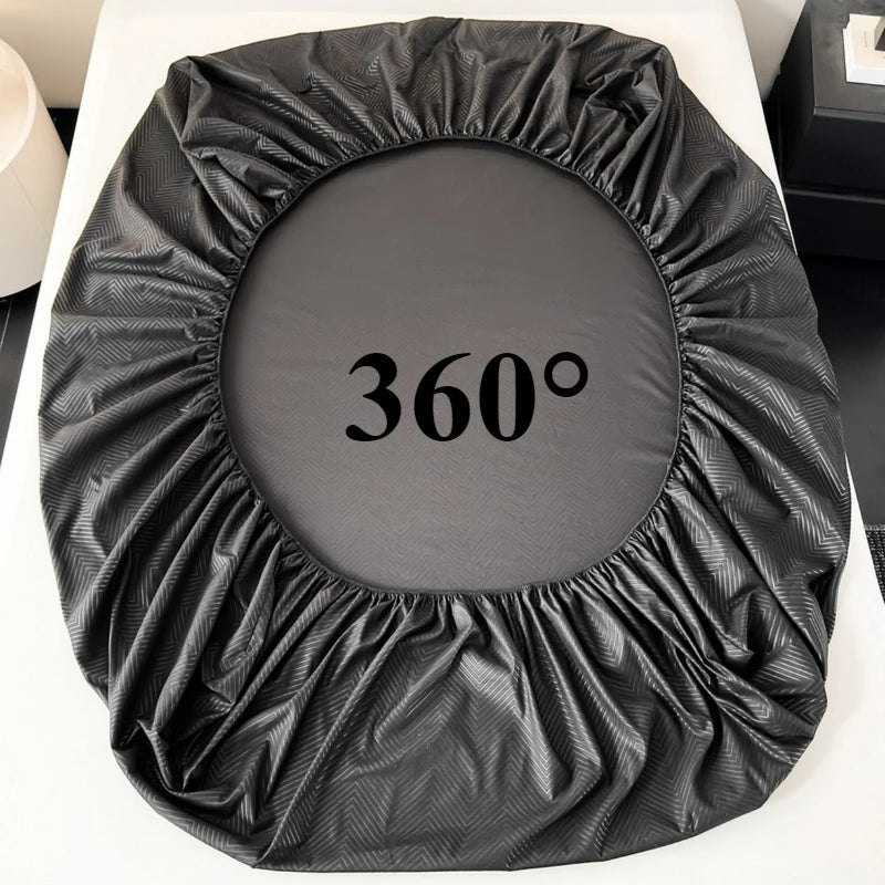 A black brushed microfiber fitted sheet with deep pockets laid flat on a white surface.