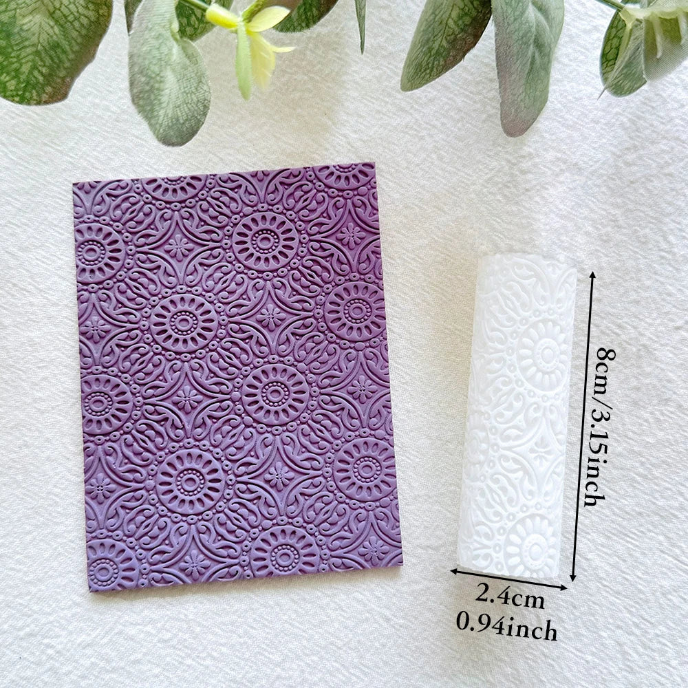 Purple clay texture roller pen with intricate baroque sunflower pattern on a white background.