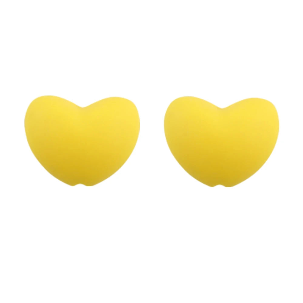 A pair of yellow silicone heart beads for DIY jewelry making