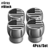 A set of four silver tire valve caps featuring an American flag design.