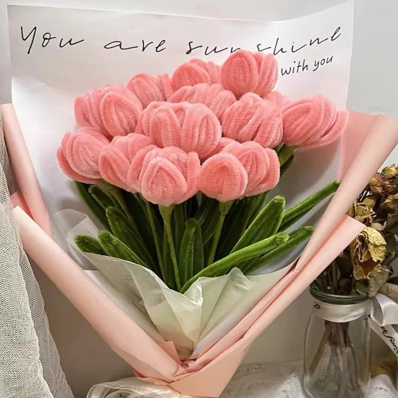 A bouquet of pink chenille craft stems shaped like tulips with a handwritten message