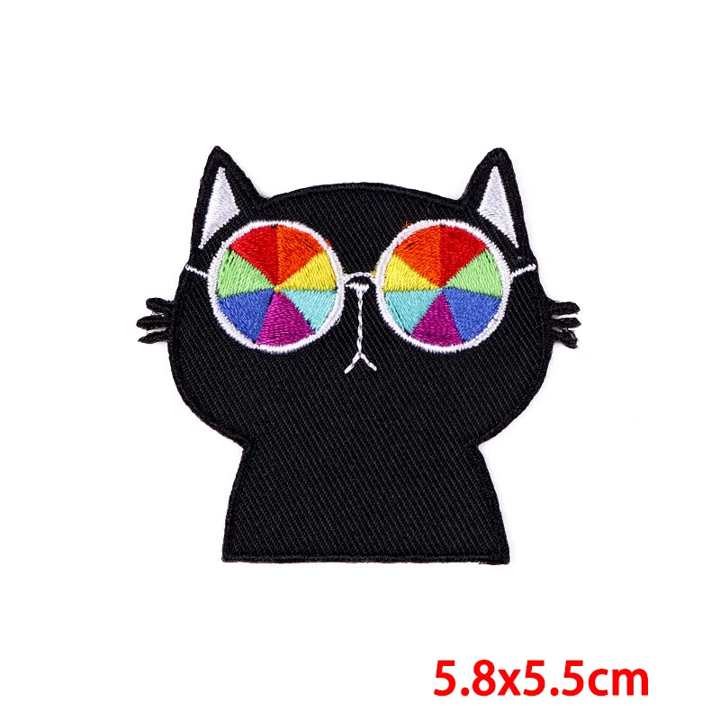 Black embroidery patch of a cartoon cat face with colorful eyes