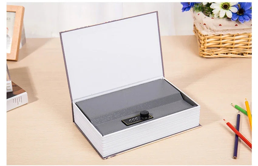 A silver hidden book safe with a combination lock is shown open on a light wooden surface.