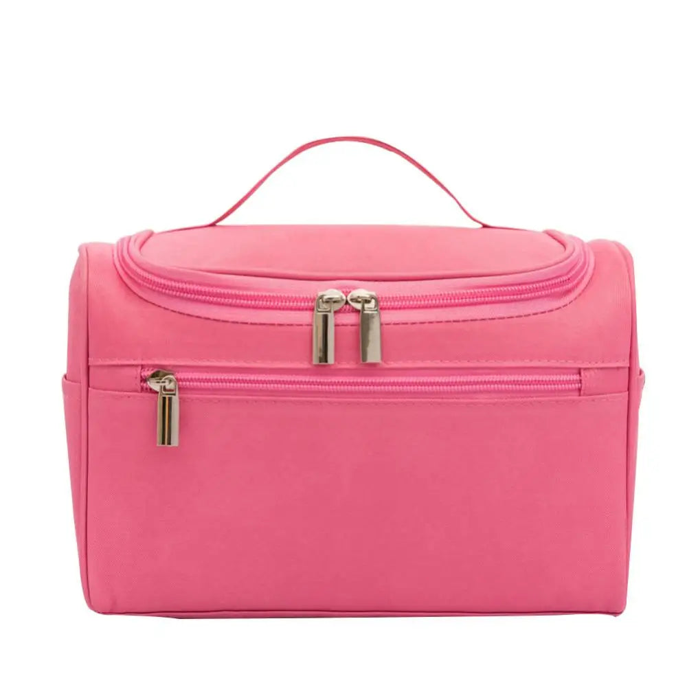 A bright pink hanging makeup bag with a zippered compartment and a pull tab.