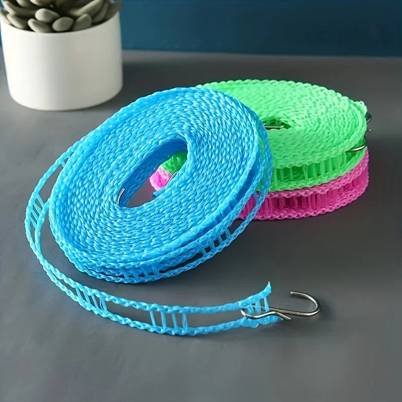 A stack of colorful windproof portable clotheslines in blue, green, and pink are displayed on a gray surface.