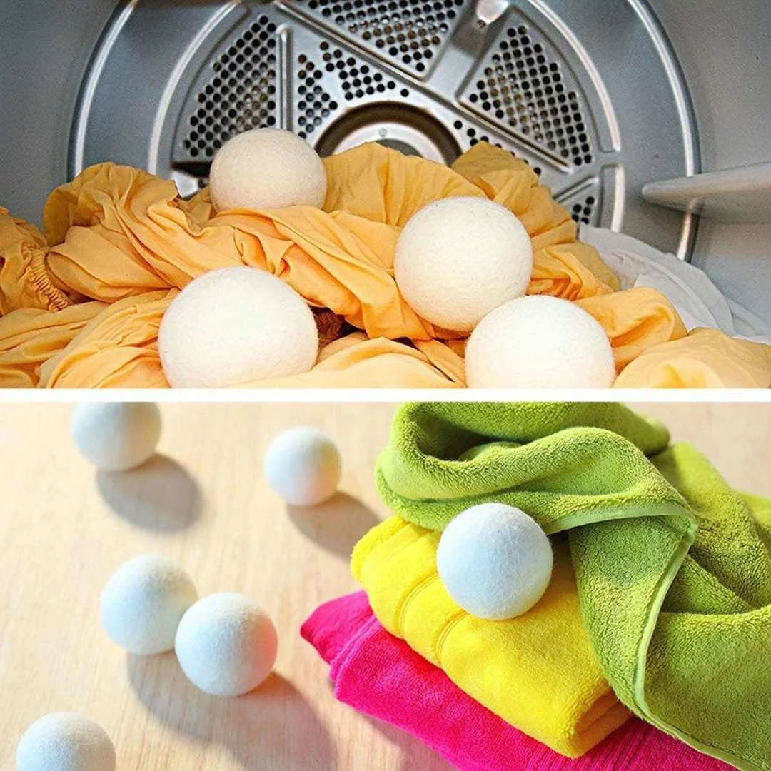 A set of three white natural wool dryer balls resting on a yellow towel and pink fabric.