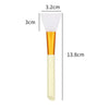A silicone facial mask brush with a white head and gold handle, shown with dimension lines.