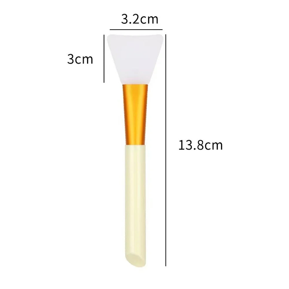 A silicone facial mask brush with a white head and gold handle, shown with dimension lines.