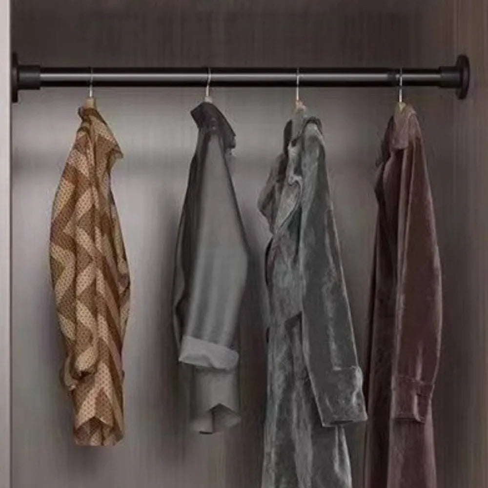 A row of hanging clothes displayed on a black tension rod with clips.