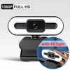 A black webcam with a built-in fill light and auto-focus lens mounted on a stand.