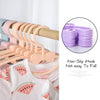 A set of ten pink and purple non-slip hook baby clothes hangers displayed next to a piece of clothing.