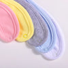 A stack of six cotton bandana bibs in pastel colors including pink, yellow, purple, and lavender.