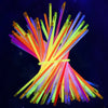 A bundle of bright, bendable glow sticks in various colors like orange, yellow, green, and purple.