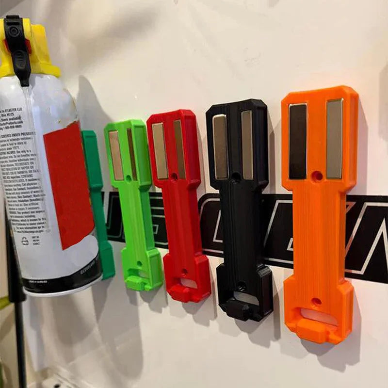 A row of magnetic wall-mounted spray can organizers in various colors including yellow, green, red, black, and orange.