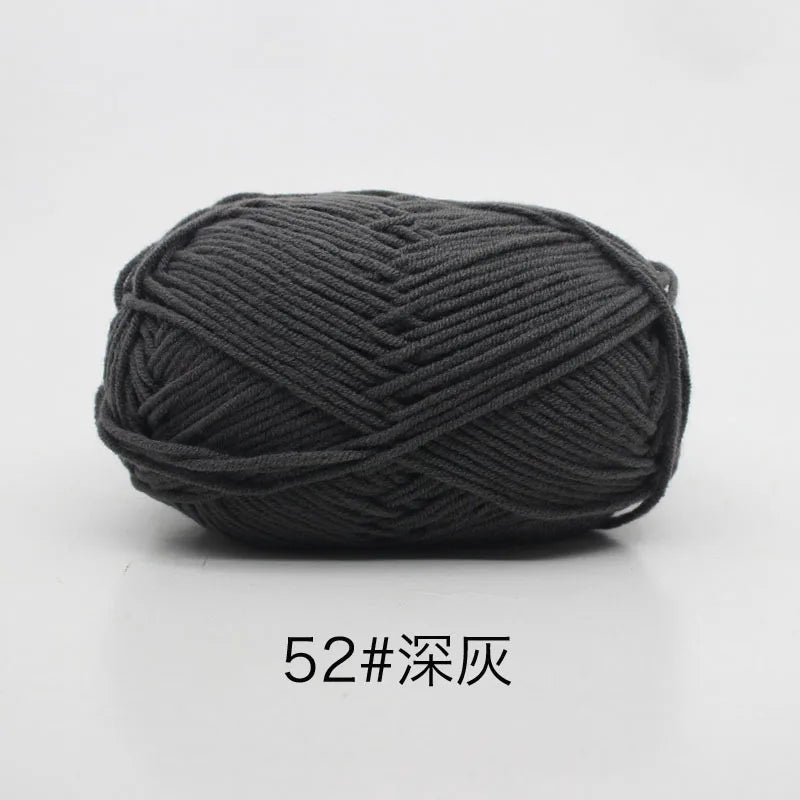 A ball of dark gray soft 4-ply milk cotton yarn for knitting and crochet.