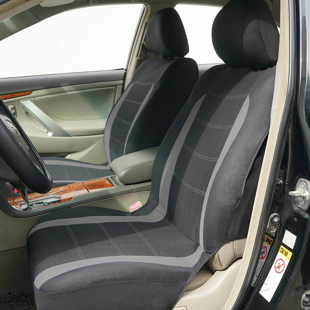 Interior view of a car seat with a two-tone gray and black fabric cover installed on the seat.