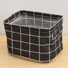 Black and white checkered storage basket with handles made of cotton and linen.