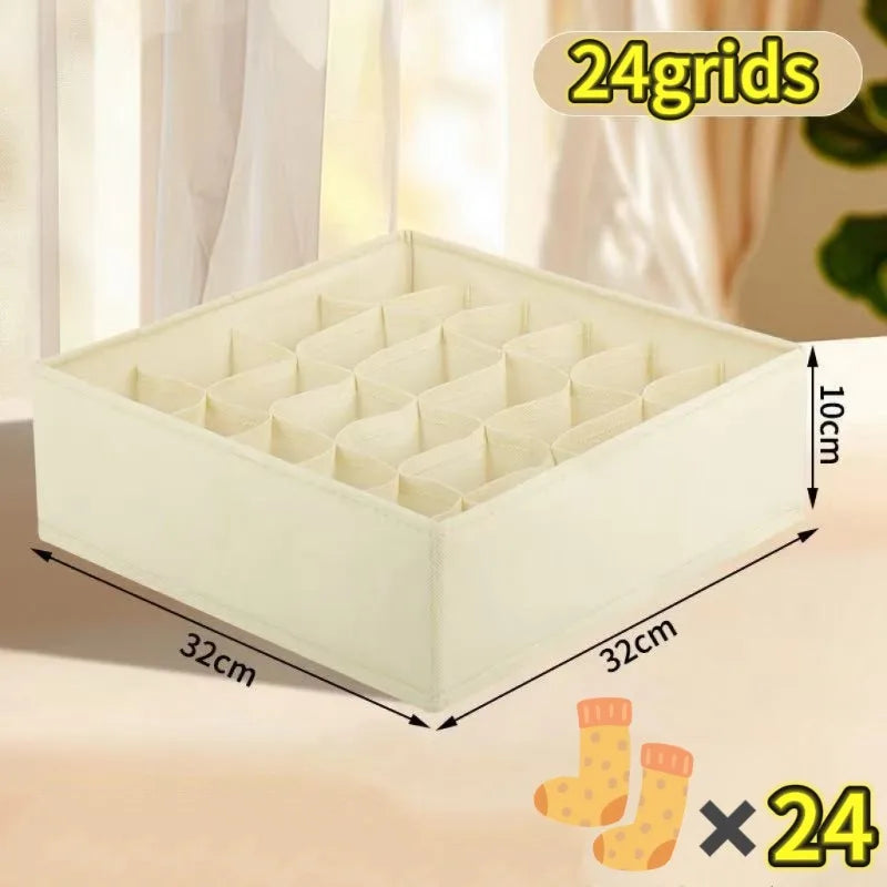 A white fabric organizer with 24 grids is shown on a table, featuring a grid of small compartments.