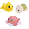 A set of three wind-up bath toys featuring cartoon turtles, ducks, and whales in yellow, beige, and pink.