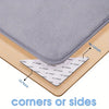 Reusable non-slip rug grippers shown demonstrating use on corners or sides of a hard floor.