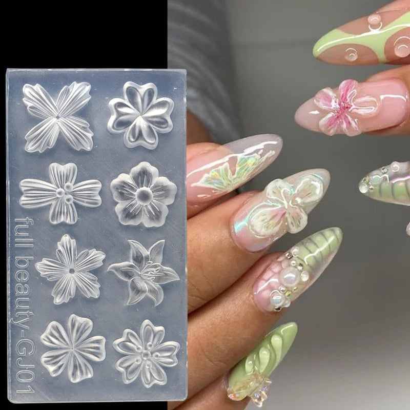 A hand displays various floral silicone nail art molds in translucent gray and pink hues.
