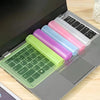 A laptop keyboard cover featuring multiple colored silicone skins for a notebook, displayed on a laptop.