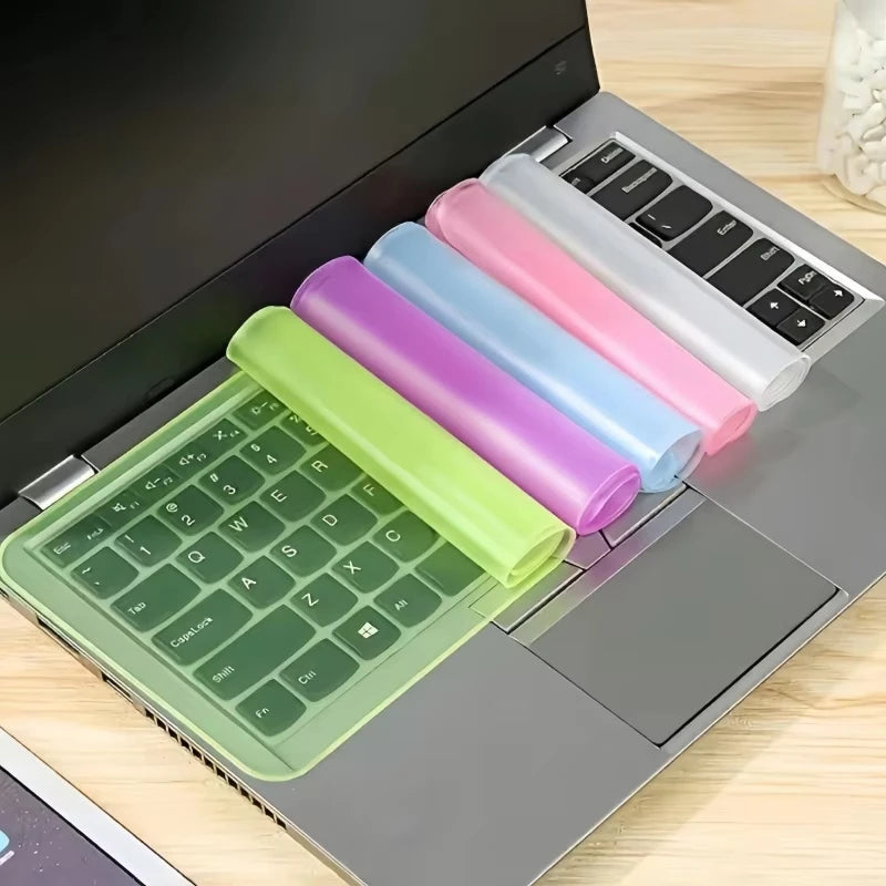 A laptop keyboard cover featuring multiple colored silicone skins for a notebook, displayed on a laptop.