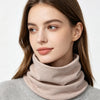 A woman models a beige cozy cotton blend neck warmer scarf over a gray sweater.