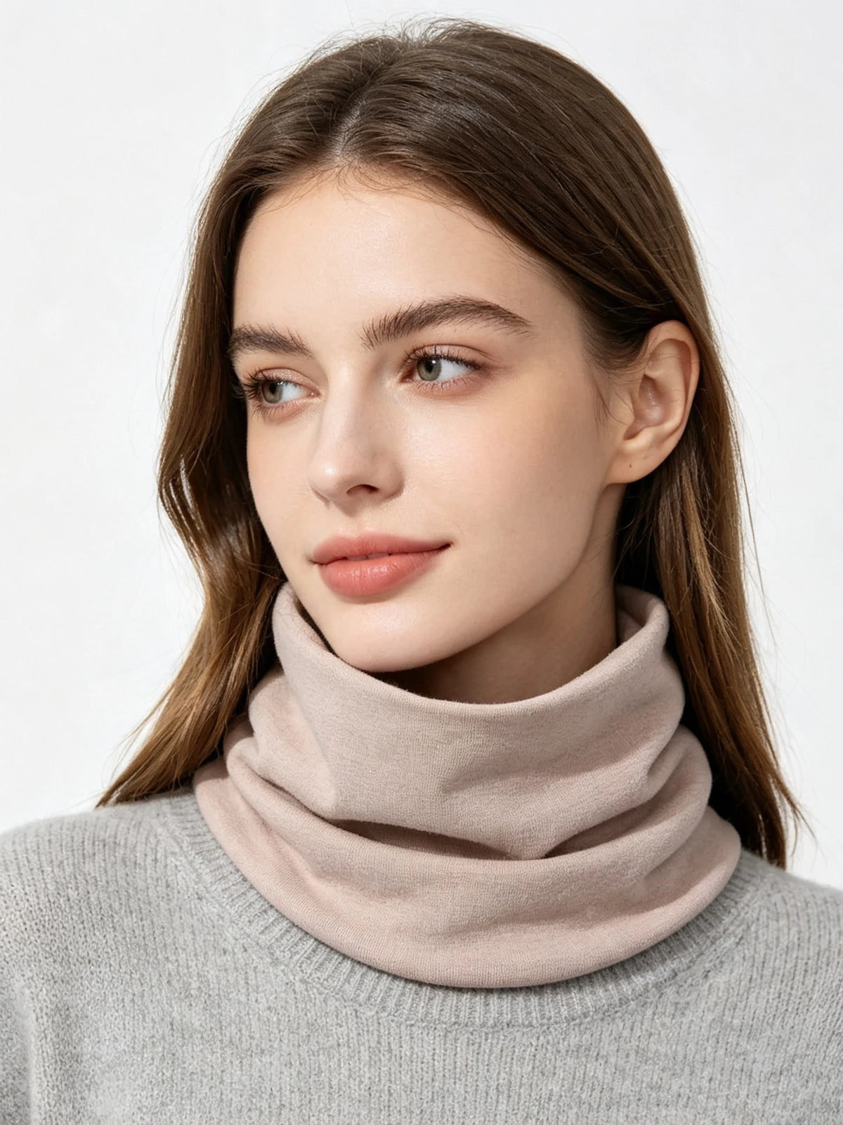A woman models a beige cozy cotton blend neck warmer scarf over a gray sweater.