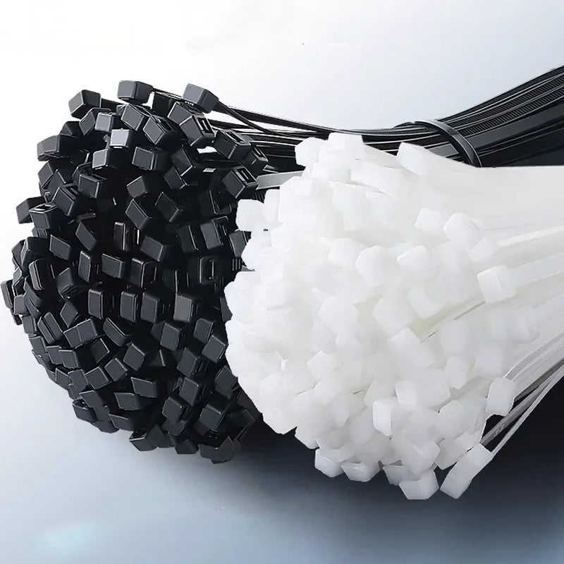 A bundle of black and white nylon self-locking cable ties for organization