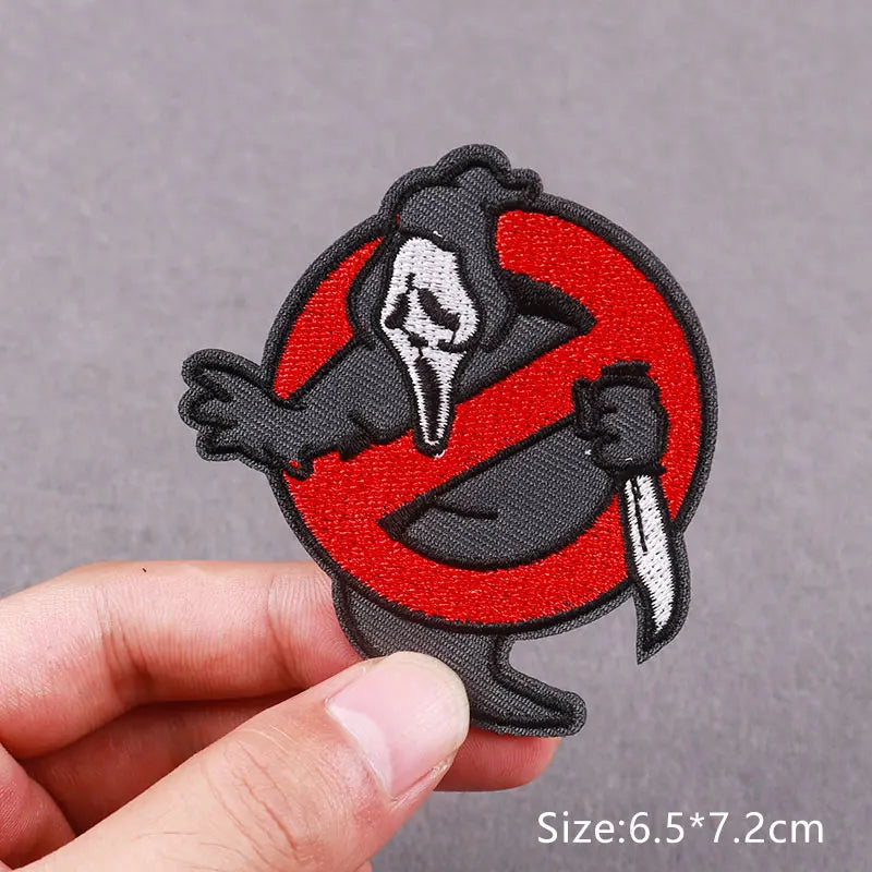 Black and white embroidered skull horror patch on a red circle