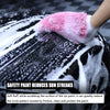 A hand wearing a pink microfiber mitt is washing car paint, reducing sun streaks and protecting the finish.