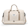 A beige lightweight nylon travel duffle bag with tan straps and a quilted pattern.