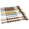 A display of food-grade silicone pacifier clips on anti-lost chains in various colors and wood tones.