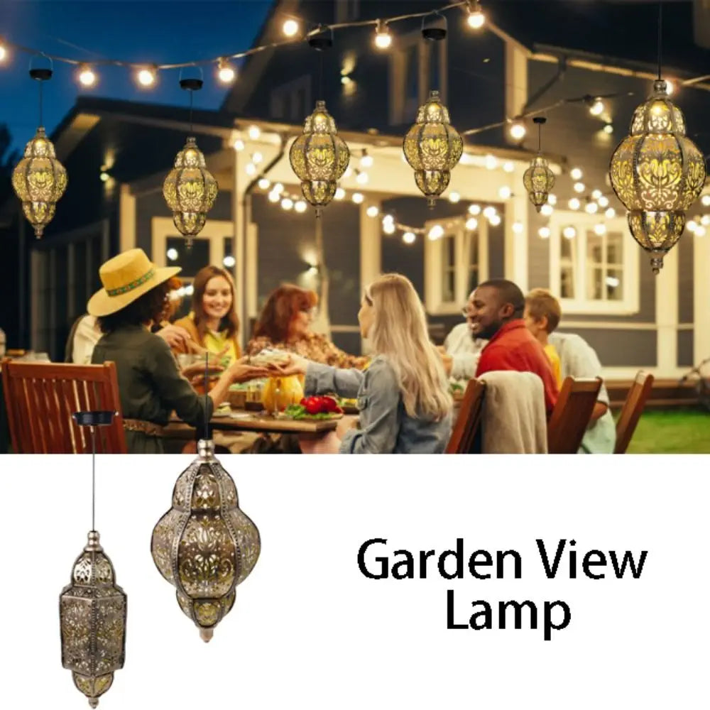 A garden view lamp featuring a Moroccan lantern design with intricate ironwork, illuminated by string lights.