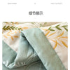 A close-up of a light mint green quilted fabric, showing the texture and stitching detail.