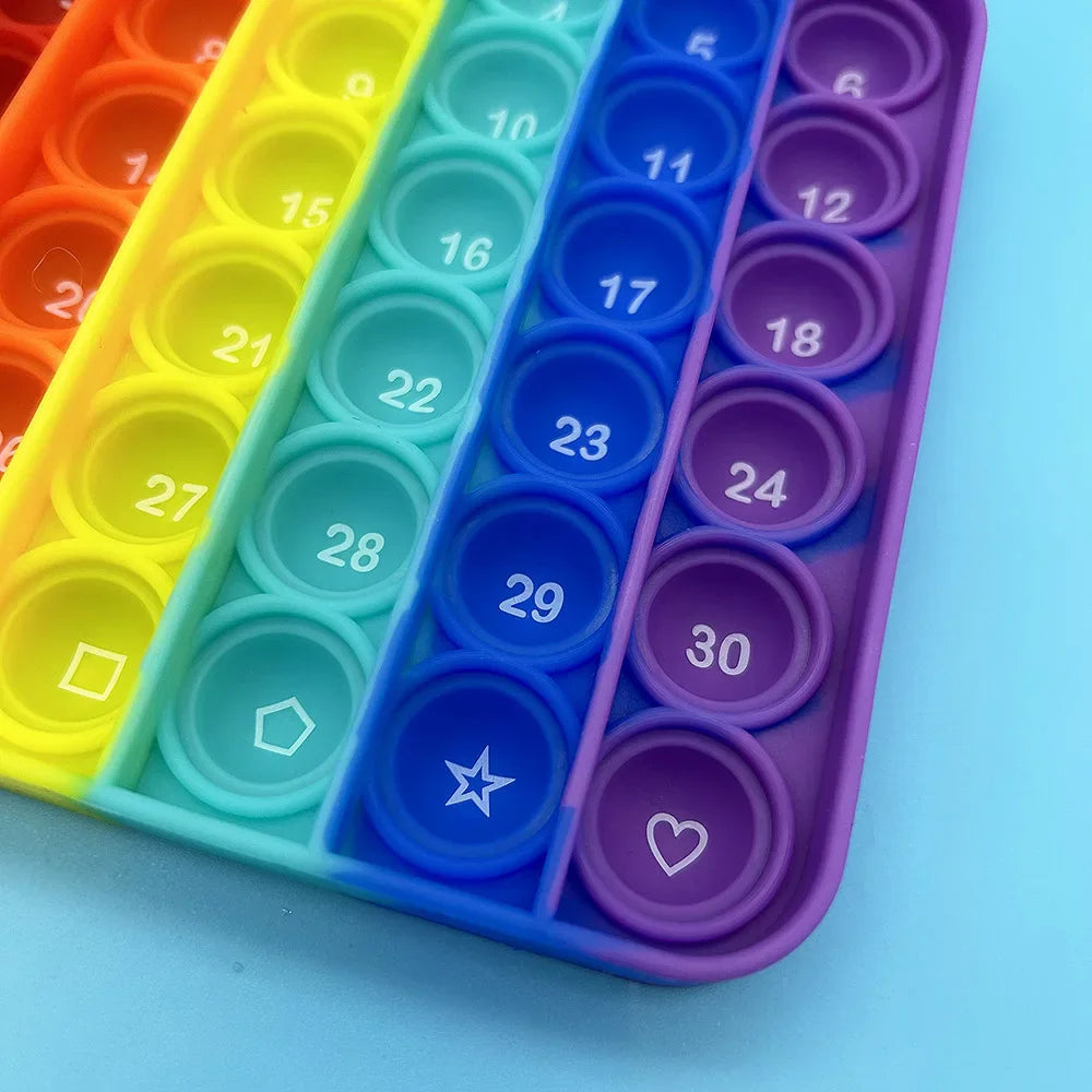 A colorful plastic fidget toy organizer with numbered and alphabet-themed buttons in various shades of yellow, green, blue, a