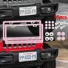 A pink crystal rhinestone license plate frame with screw caps is shown mounted on a black vehicle grille.