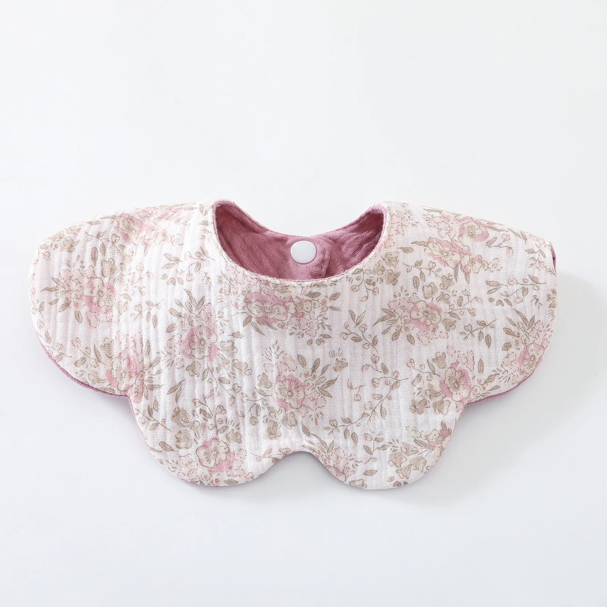 A pink floral patterned baby feeding bib made of 6-layer cotton with a small button closure.