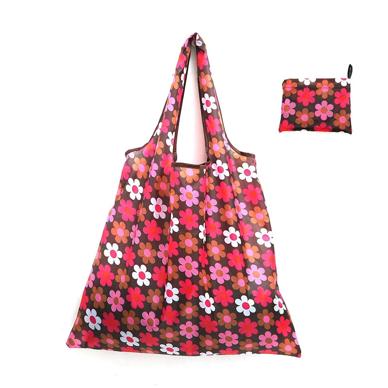 A reusable shopping tote bag in a floral pattern with a matching small carry pouch.