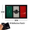 An IR reflective patch featuring a green, gray, and red design with an eagle skull motif and hook and loop backing.