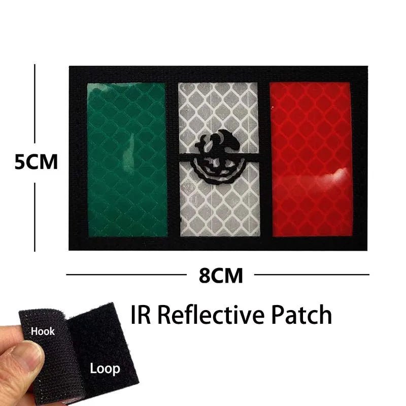 An IR reflective patch featuring a green, gray, and red design with an eagle skull motif and hook and loop backing.