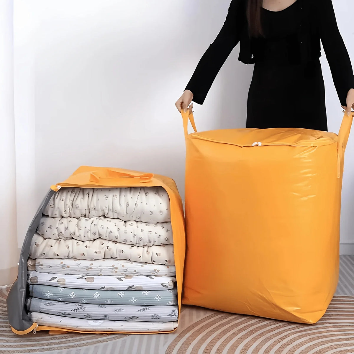 An orange heavy-duty waterproof moving bag filled with rolled textiles sits next to a large yellow bag.