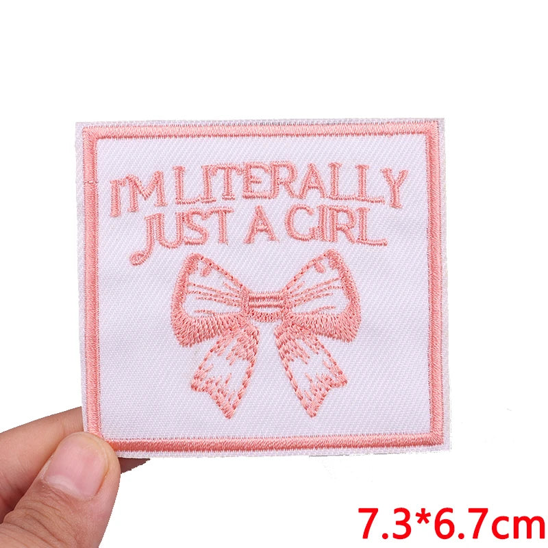 Pink embroidered patch with text I'm literally just a girl and a bow