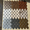 A mosaic wall featuring hexagonal tiles in various earthy tones including beige, brown, gray, and muted green.