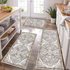 A long rectangular gray and white patterned kitchen rug placed on a wooden floor.